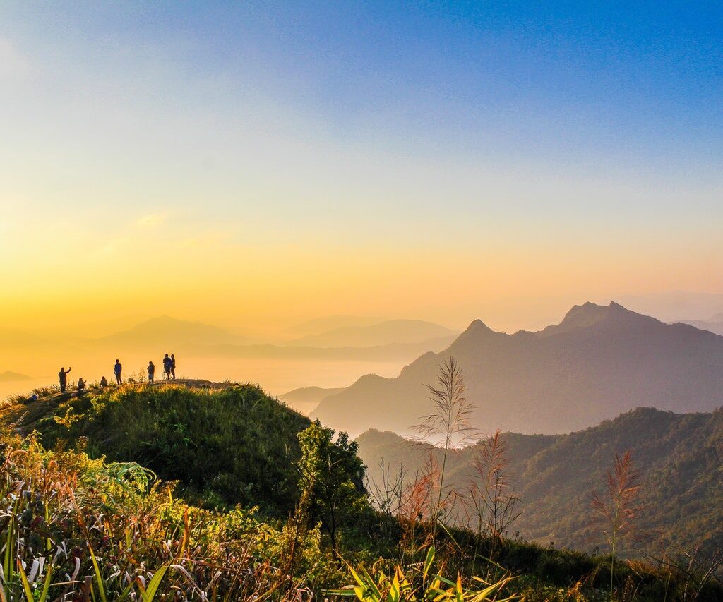 photo of people standing on top of mountain near grasses 733162.jpg